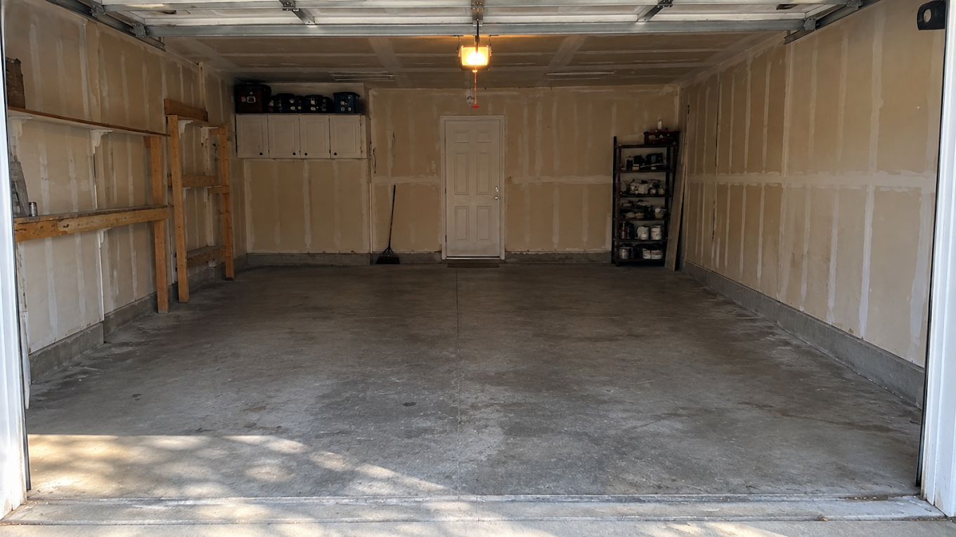 The same garage completely empty and swept clean after the Two Bros junk removal cleanout
